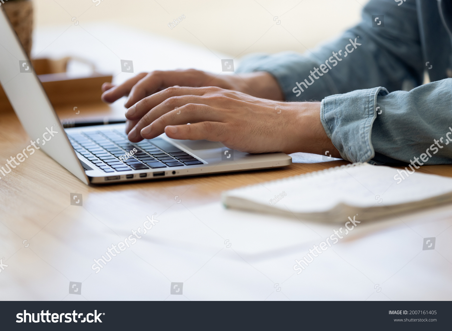 Close up view male hands writes on laptop. Entrepreneur man sit at desk work on modern wireless notebook, do remote telecommute, search information on internet, professional application usage concept #2007161405