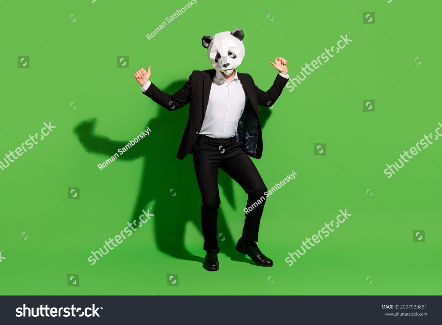 Photo of hipster absurd man dance disco wear panda mask black tux shoes isolated on green color background #2007930881