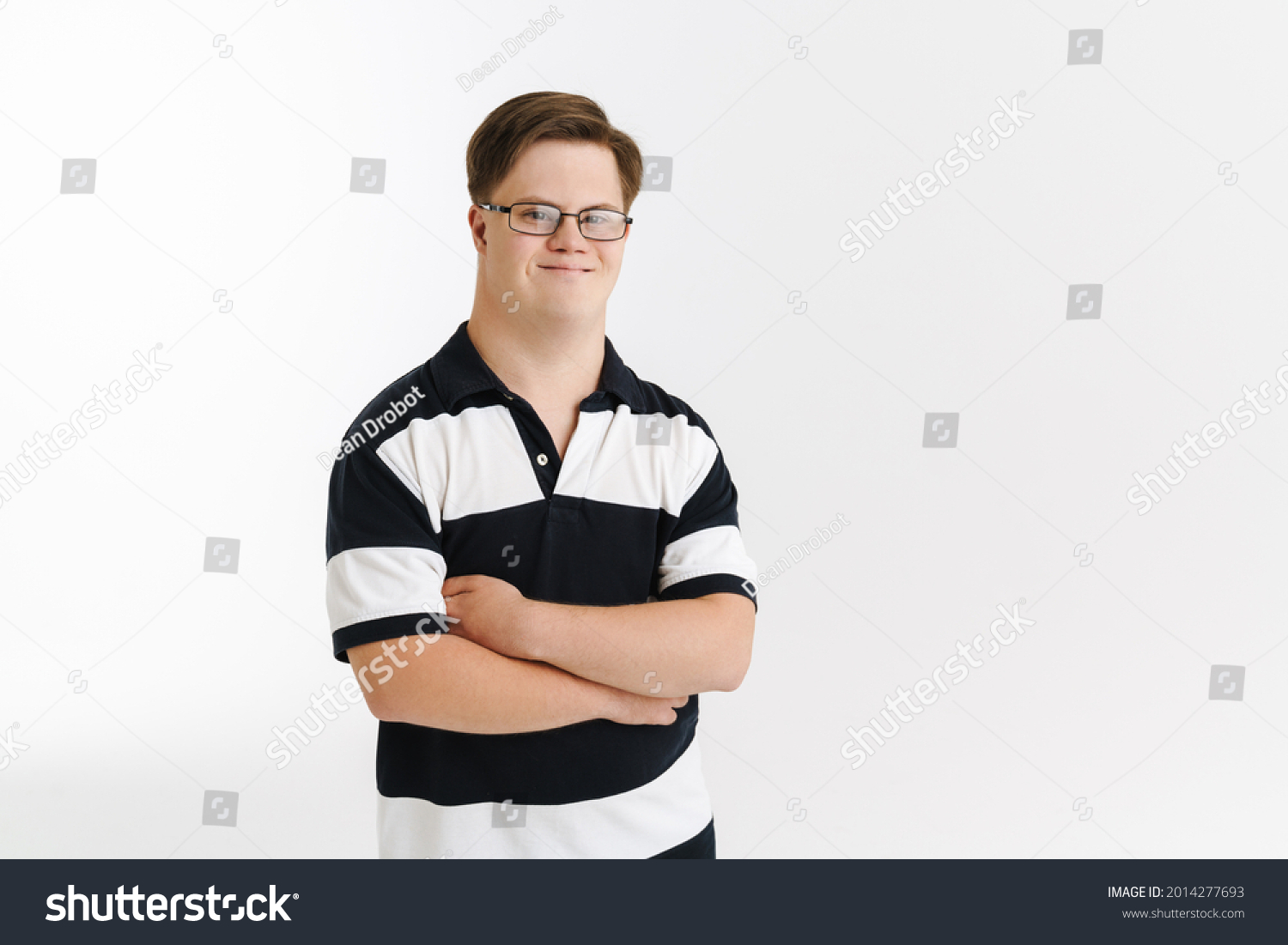 Young man with down syndrome smiling and looking at camera isolated over white background #2014277693