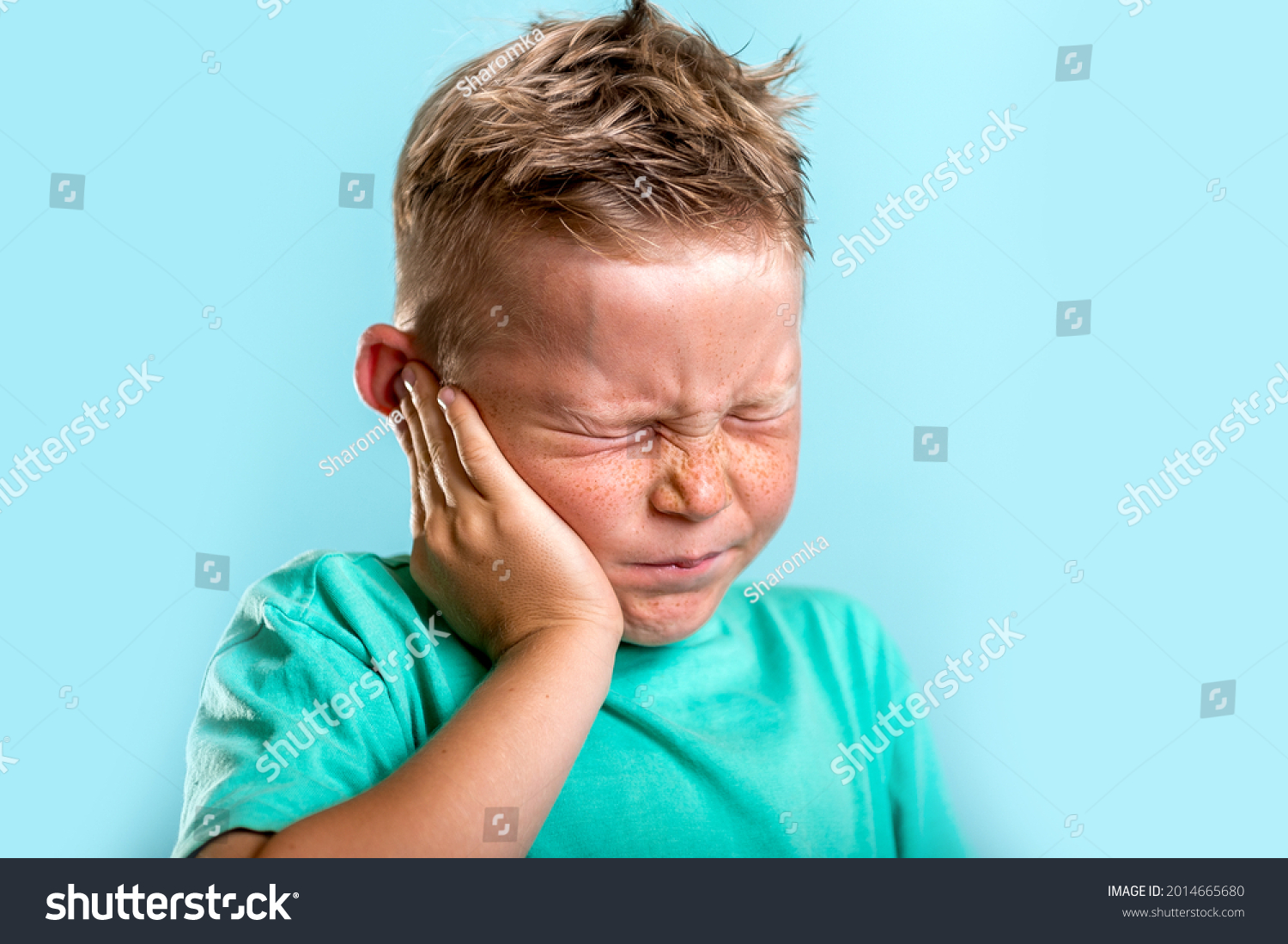Child has earache. School boy has sore ear. Little kid covered ear with hand and closed eyes. Kid suffering from otitis. Vaccination for being health. Toothache. #2014665680