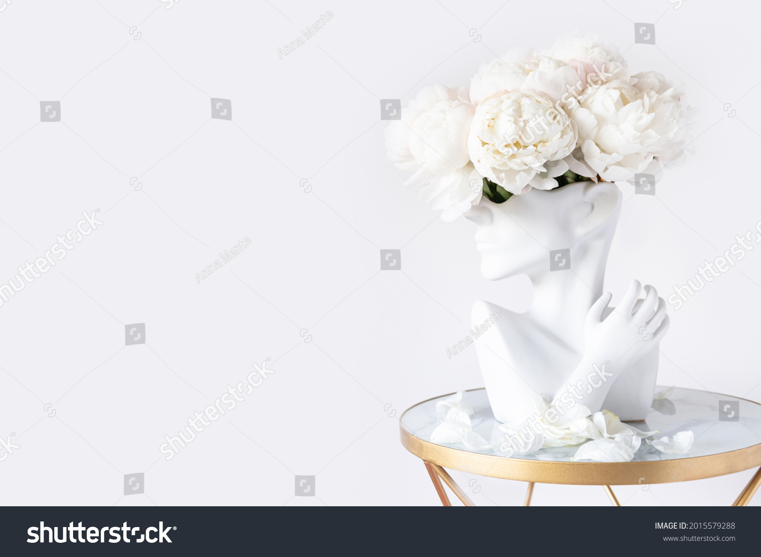 Fresh bunch of white peonies in vase in shape of womens face on light background. Trendy Ceramic Vase of human head, Handmade Modern Statue Art Flower Vase. Card Concept, copy space for text #2015579288