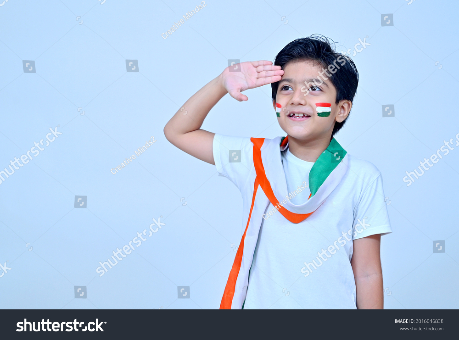 Little boy saluting wearing white kurta pajamas on the occasion of Indian Independence day celebration #2016046838