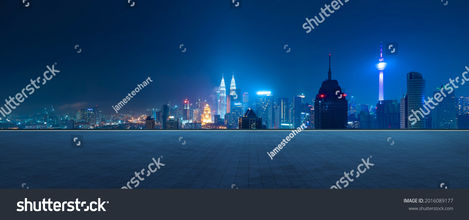 Panoramic view of empty concrete tiles floor with city skyline. Night scene. #2016089177