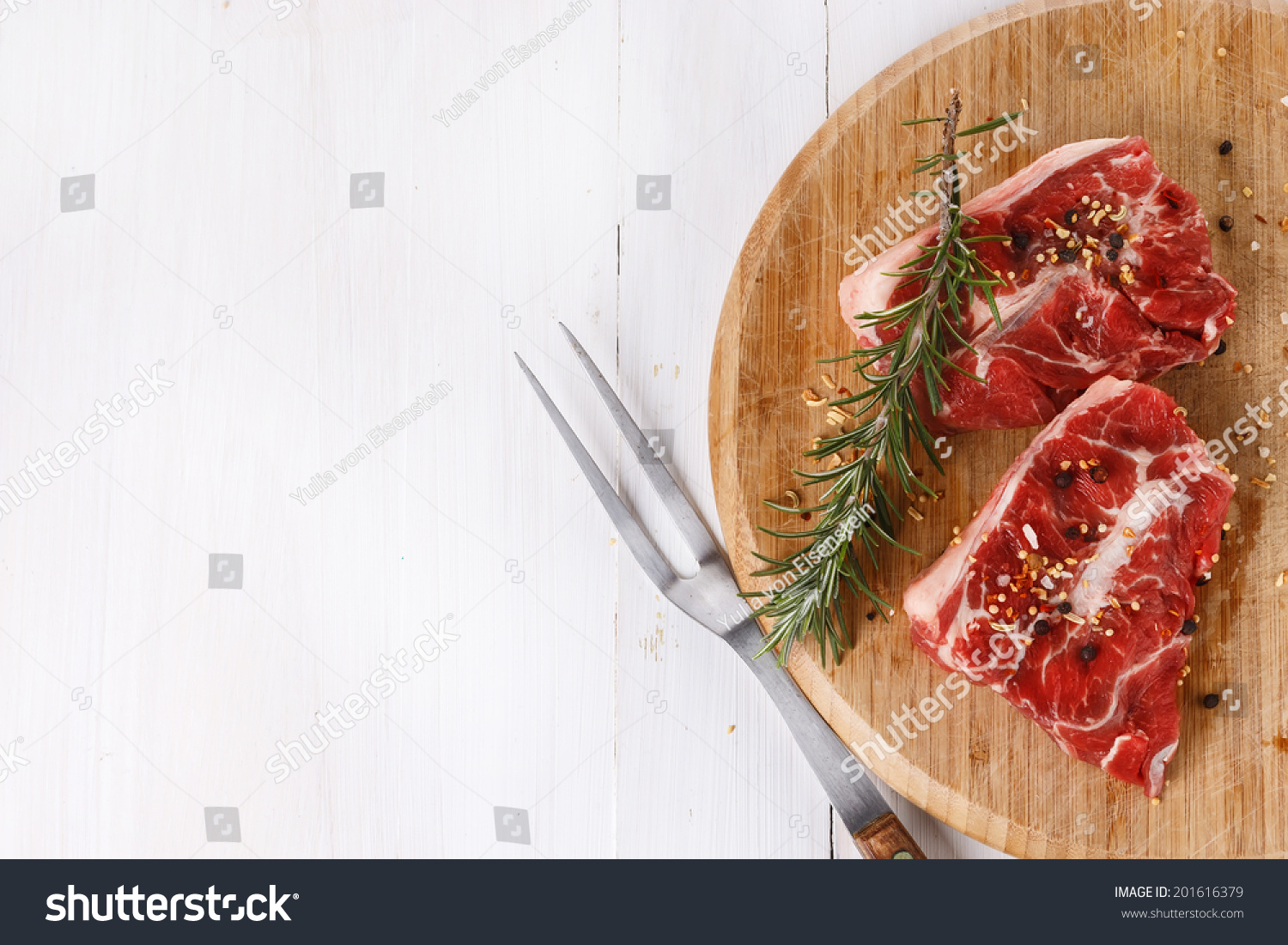 Background with red meat and rosemary over white wooden table. Top view #201616379