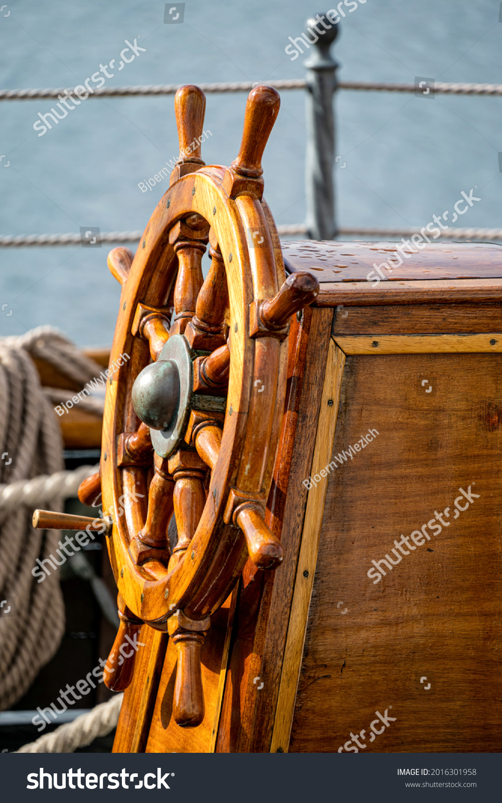 wooden ship's wheel of a tall ship #2016301958
