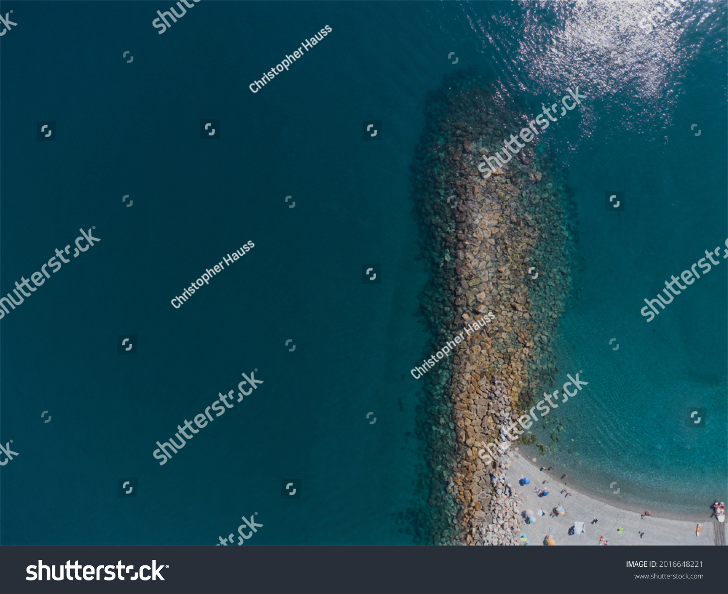 Breakwater stones in the ocean at the beach on a sunny day #2016648221