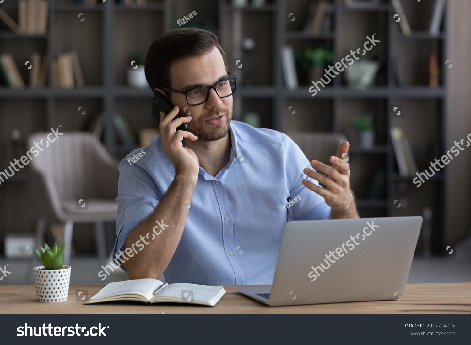 Counseling caller. Millennial man agent realtor work from home office sit by pc give professional advice to client by phone. Young businessman talk on cellphone discuss business project with colleague #2017794005
