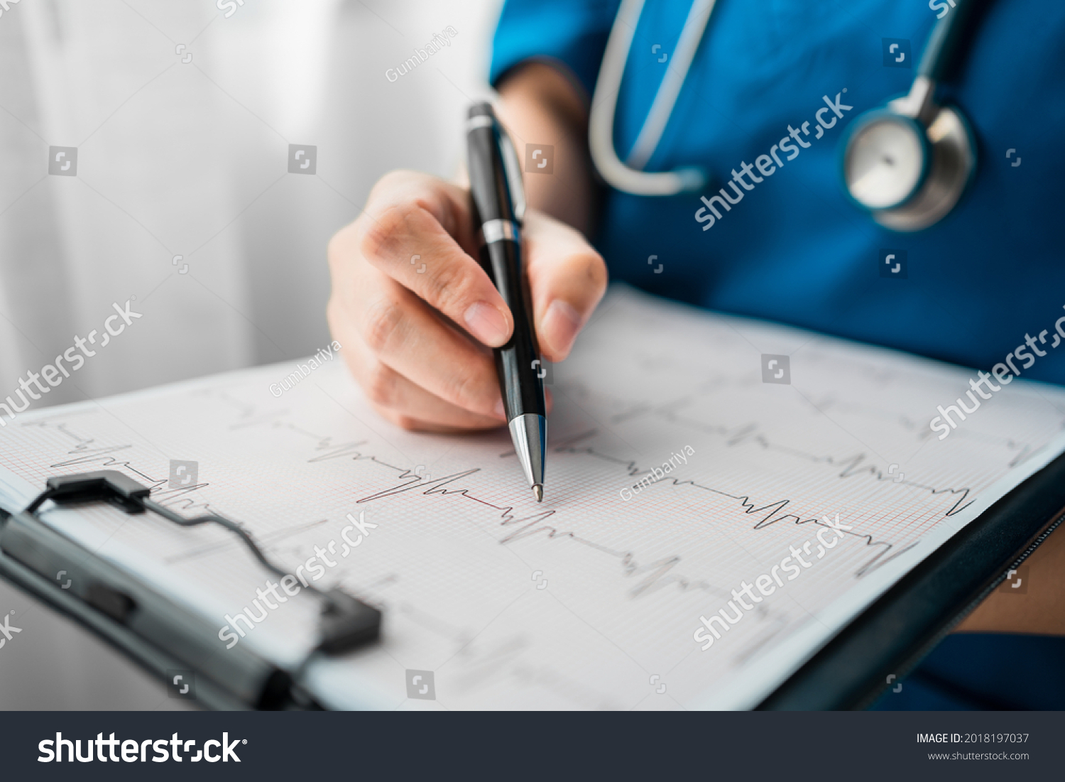 Close up of professional doctor reading and recording cardio diagram graph reports of a patient, Exercise Stress Test (EKG) Check Reports, medical health care concept. #2018197037