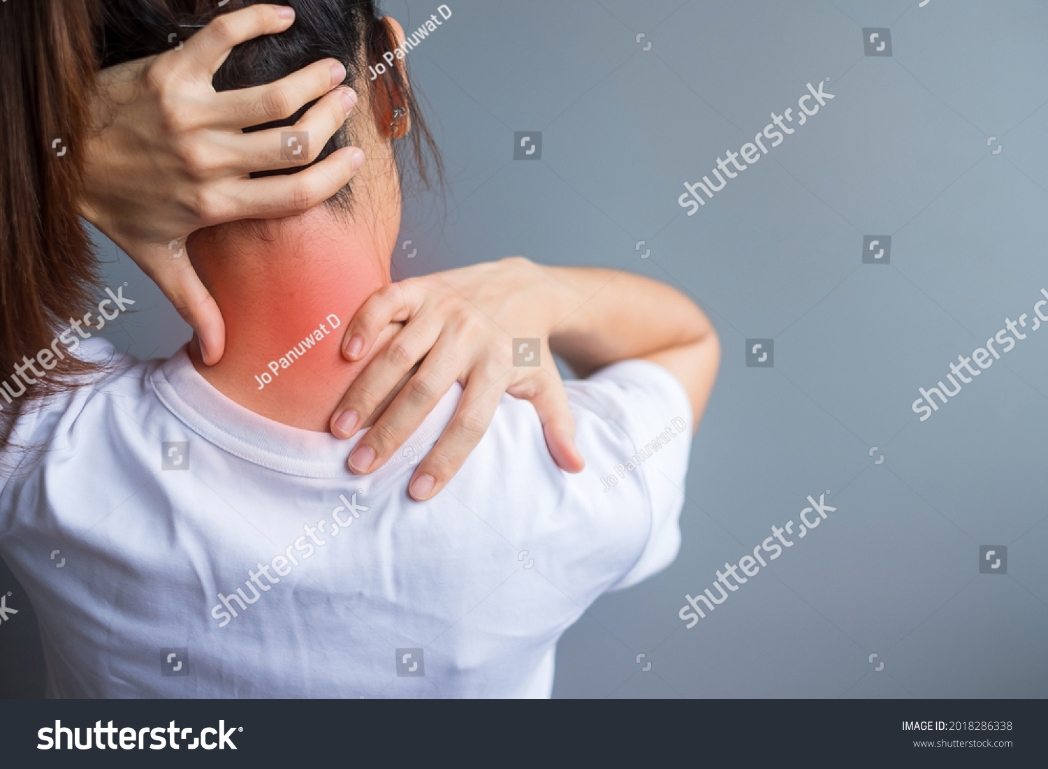 woman with her neck sprain, muscle painful during overwork. Girl having body problem after wake up. Stiff neck, office syndrome and ergonomic concept #2018286338
