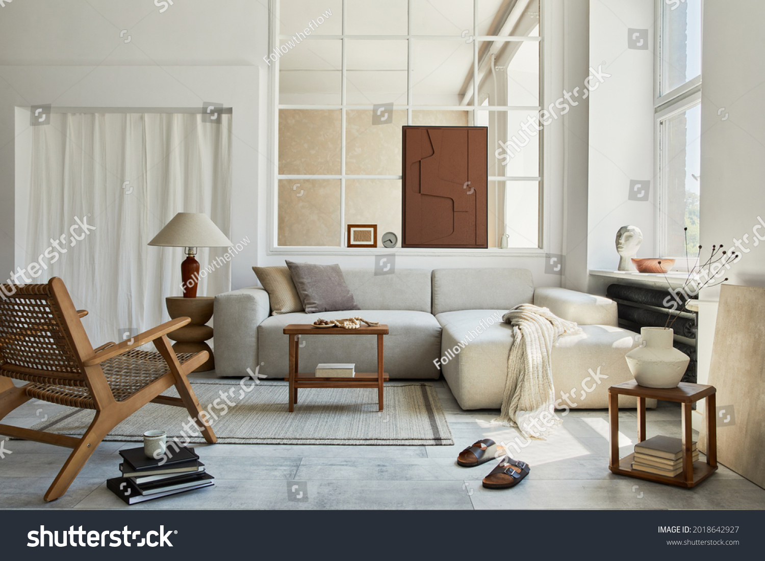 Creative composition of stylish and cozy living room interior with mock up structure painting, grey corner sofa, window, armchair and personal accessories. Beige neutral colors. Template. #2018642927