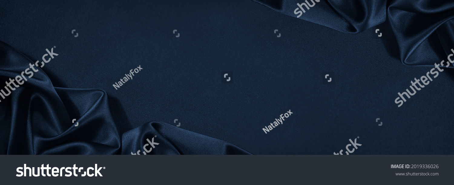 Beautiful dark blue silk satin background. Soft folds on shiny fabric. Luxury background with copy space for text, design. Web banner. Flat lay, top view table.Birthday, Christmas, Valentine's Day. #2019336026