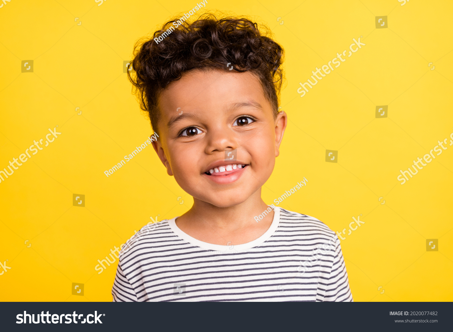 Photo portrait cheerful small boy smiling in striped shirt isolated bright yellow color background #2020077482