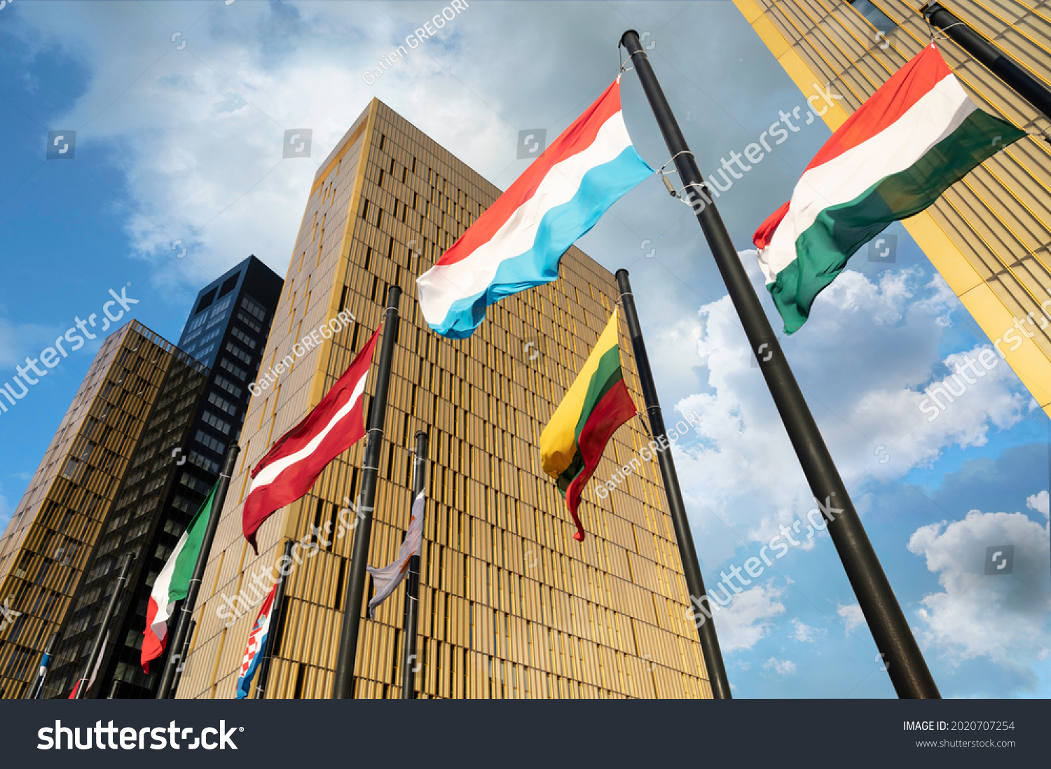 European Flags flapping in the wind, in front of European Union Court of Justice building in Luxembourg Kirchberg. Flags of Luxembourg, Hungary, Lithuania, Austria... #2020707254