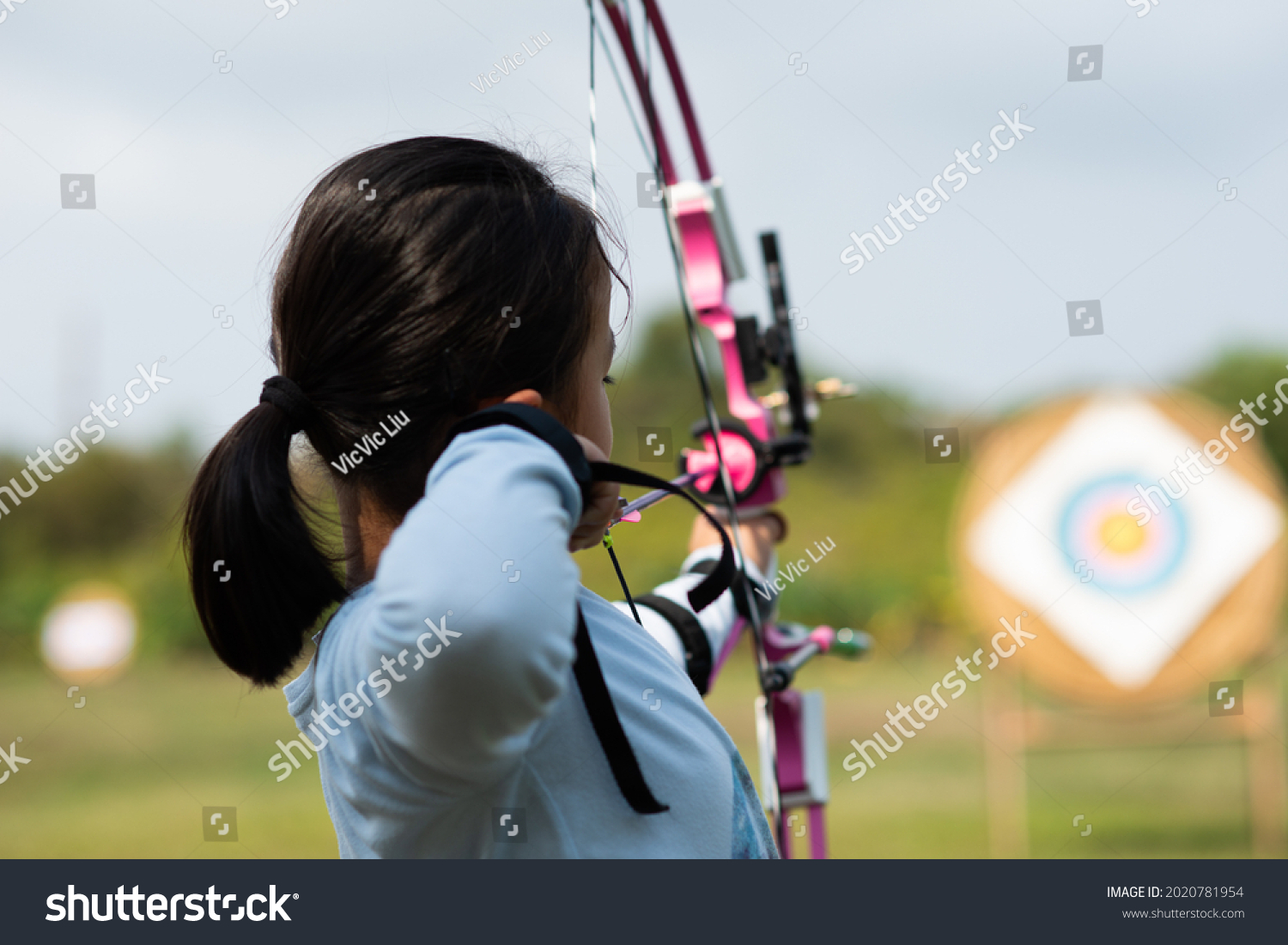 Children  learn compound bows in archery lessons. #2020781954