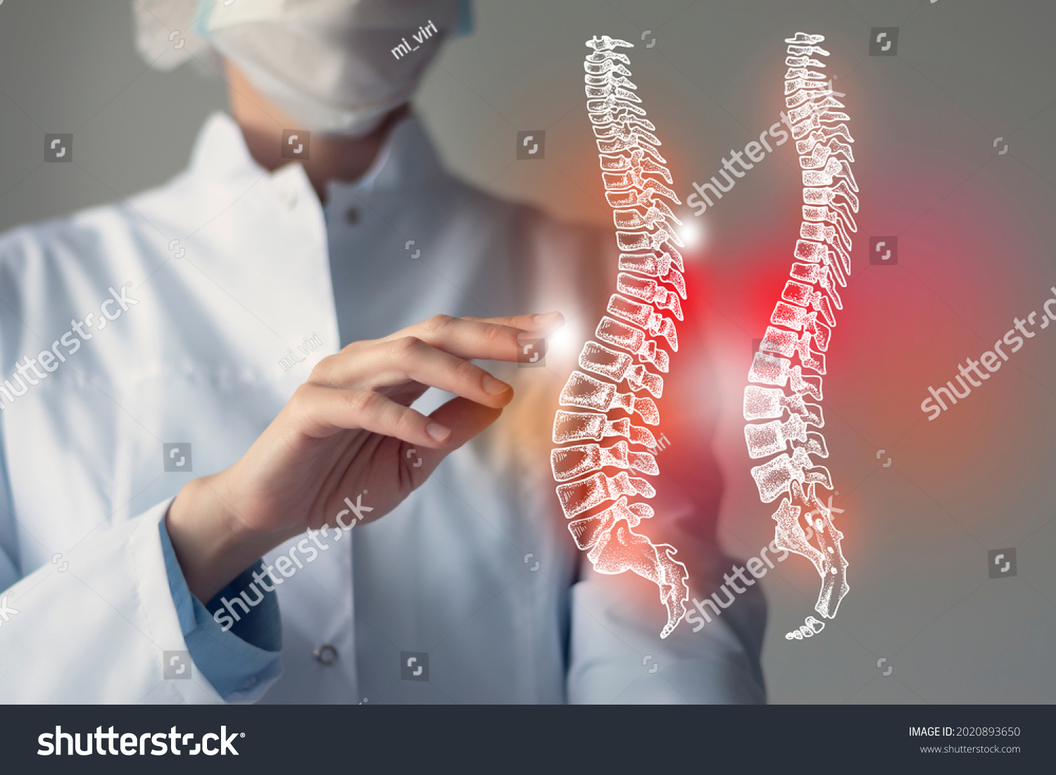 Female doctor touches virtual Spine in hand. Blurred photo, handrawn human organ, highlighted red as symbol of disease. Healthcare hospital service concept stock photo #2020893650