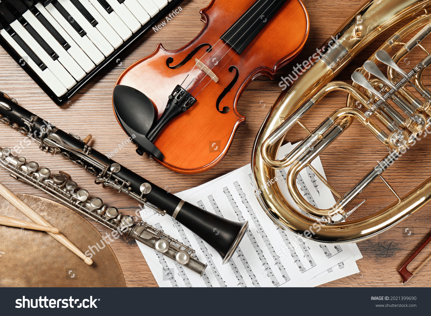 Set of different musical instruments on wooden background, flat lay #2021399690