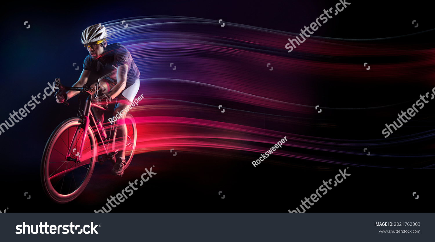 Spost background with copyspace. Cyclist. Dramatic colorful portrait. Speed and powerfull. #2021762003