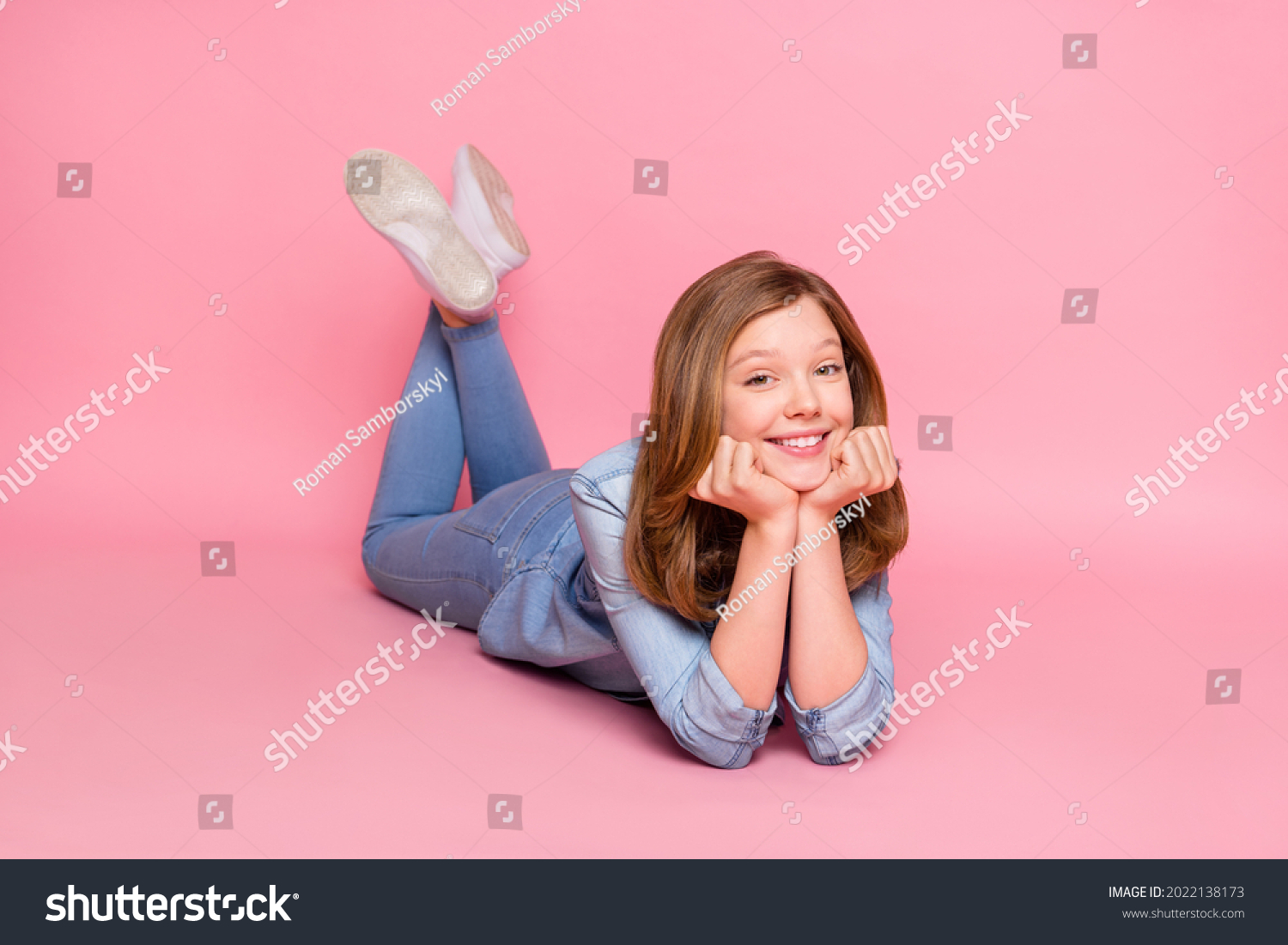 Full body profile side photo of young attractive girl happy positive smile lying floor isolated over pink color background #2022138173