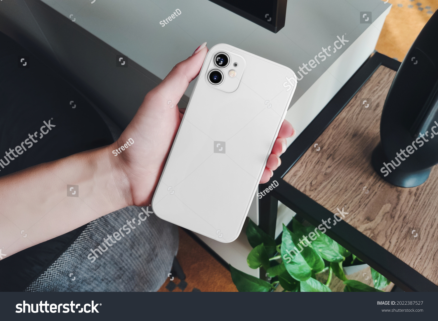 Phone in case in the hand of a girl mockup #2022387527