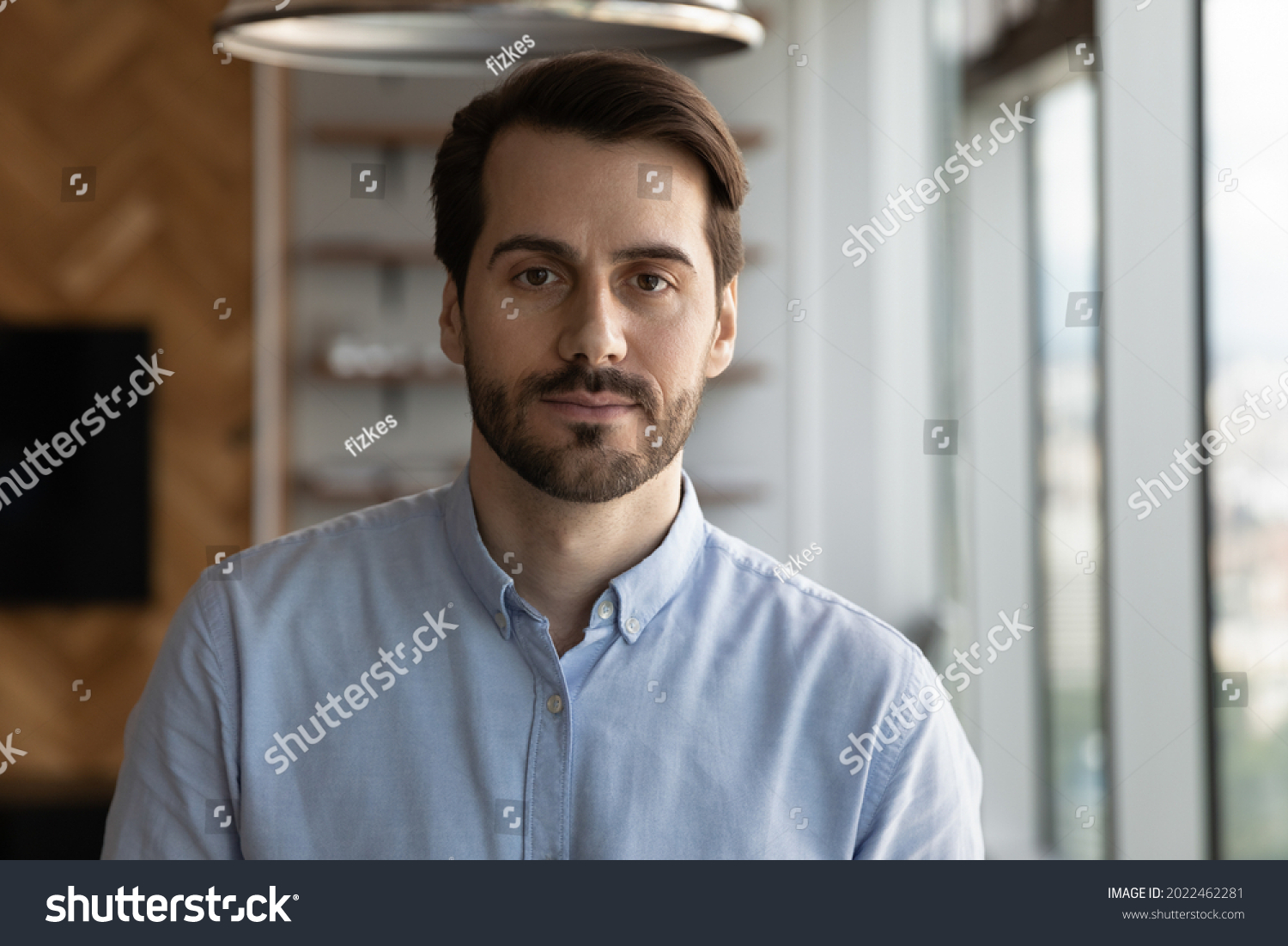 Portrait of serious confident businessman, entrepreneur, company leader, employee. Head shot of millennial 30s bearded man in casual shirt looking at camera. Business profile picture #2022462281