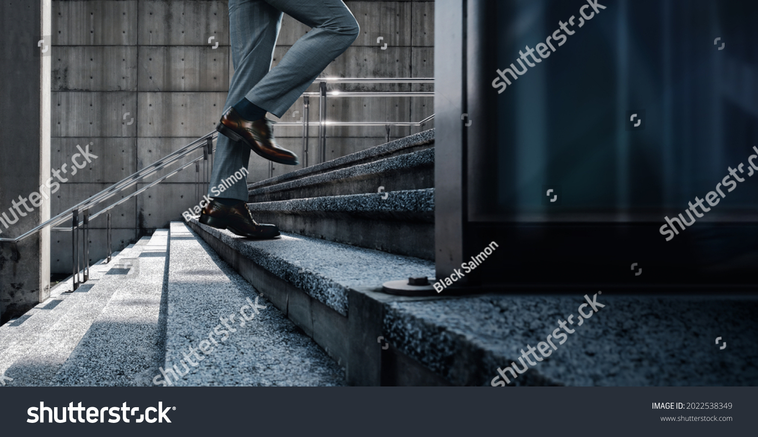 Motivation and challenging Concept. Steps Forward into a Success. Low Section of Businessman Walking Up on Staircase. City Scene #2022538349