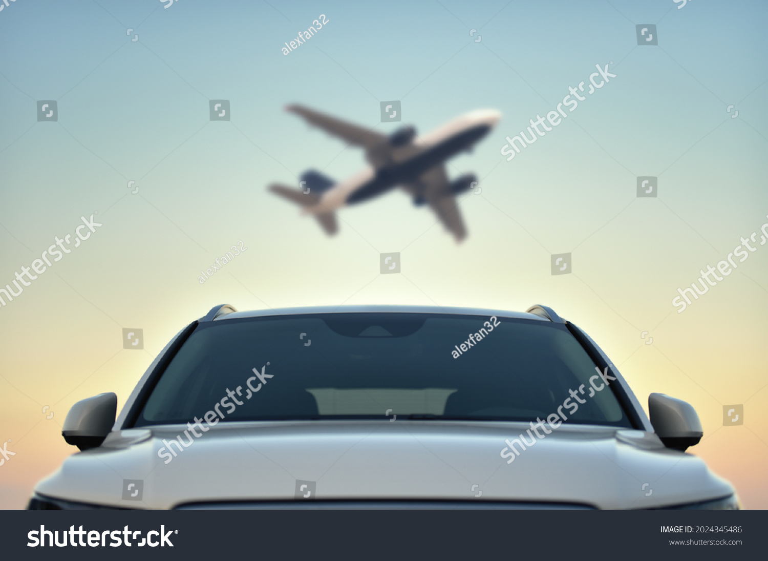 Parked Car in airport with taking off airplane on sky background. Transfer concept. #2024345486