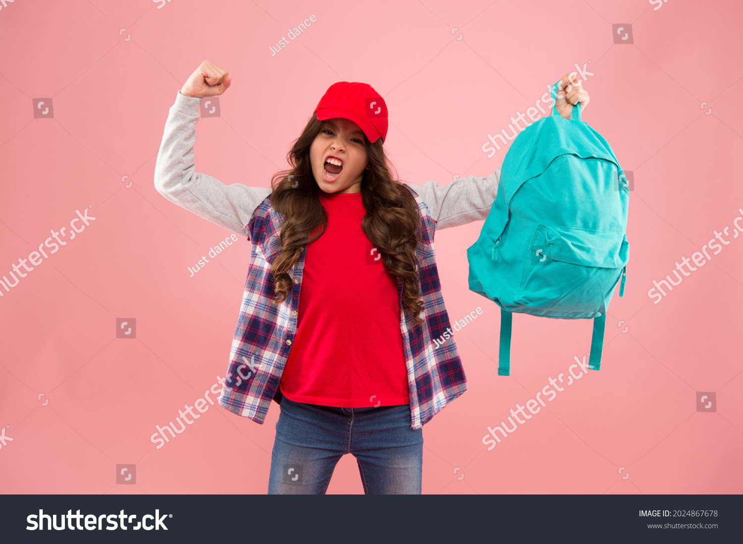 Powerful kid. Carrying things in backpack. Learn how fit backpack correctly. Girl little fashionable kid carry backpack. Useful fashion accessory. Schoolgirl red cap long hair with school backpack #2024867678