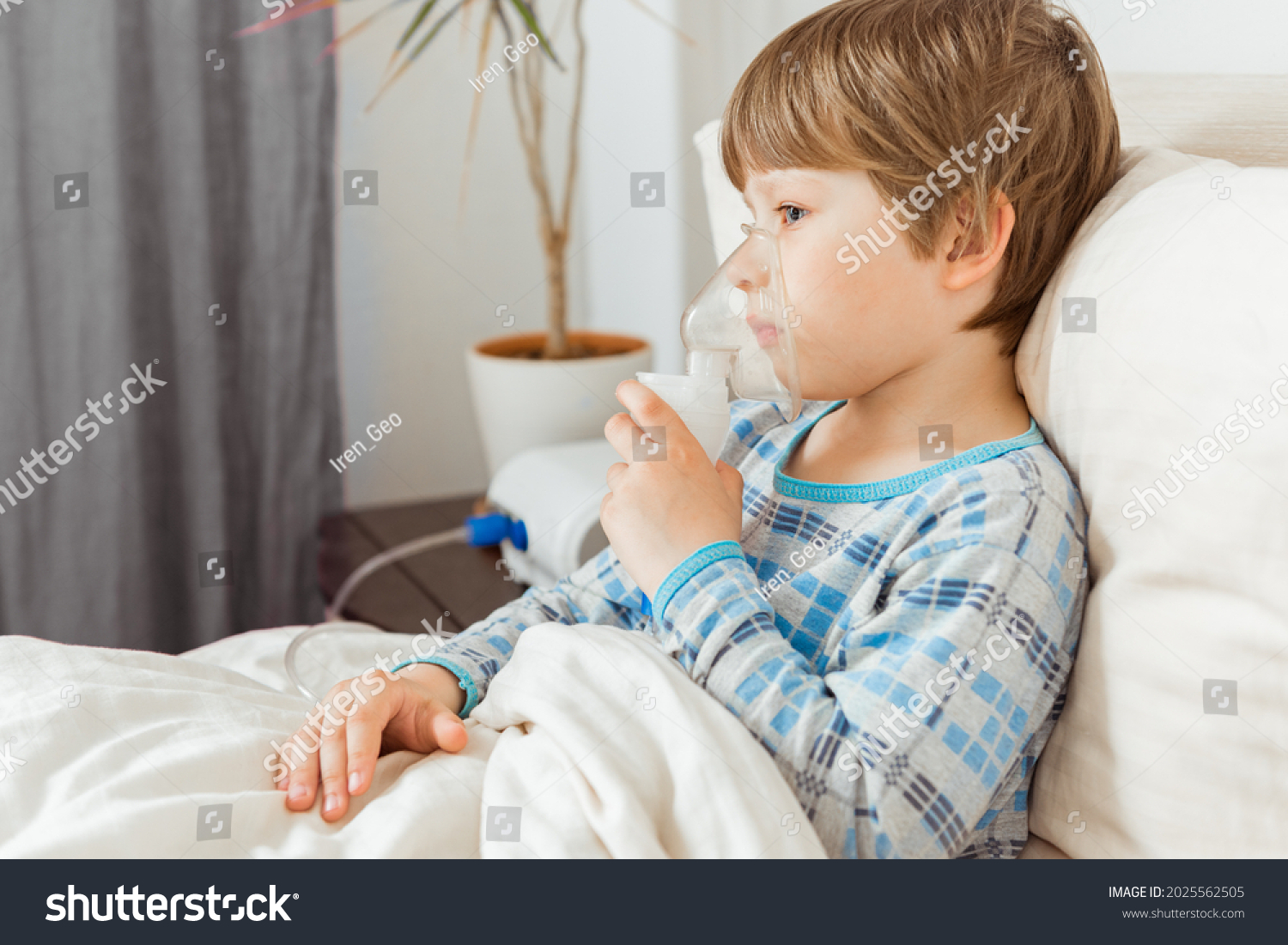 Boy with a respiratory syncytial virus, inhaling medication through an inhalation mask. Flu, coronavirus concept #2025562505