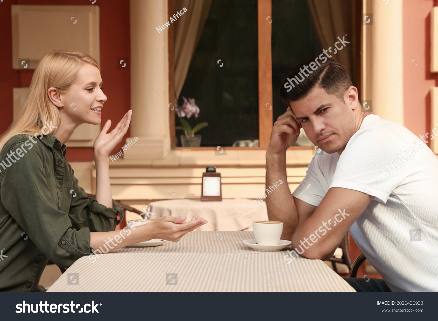 Man having boring date with talkative woman in outdoor cafe #2026436933