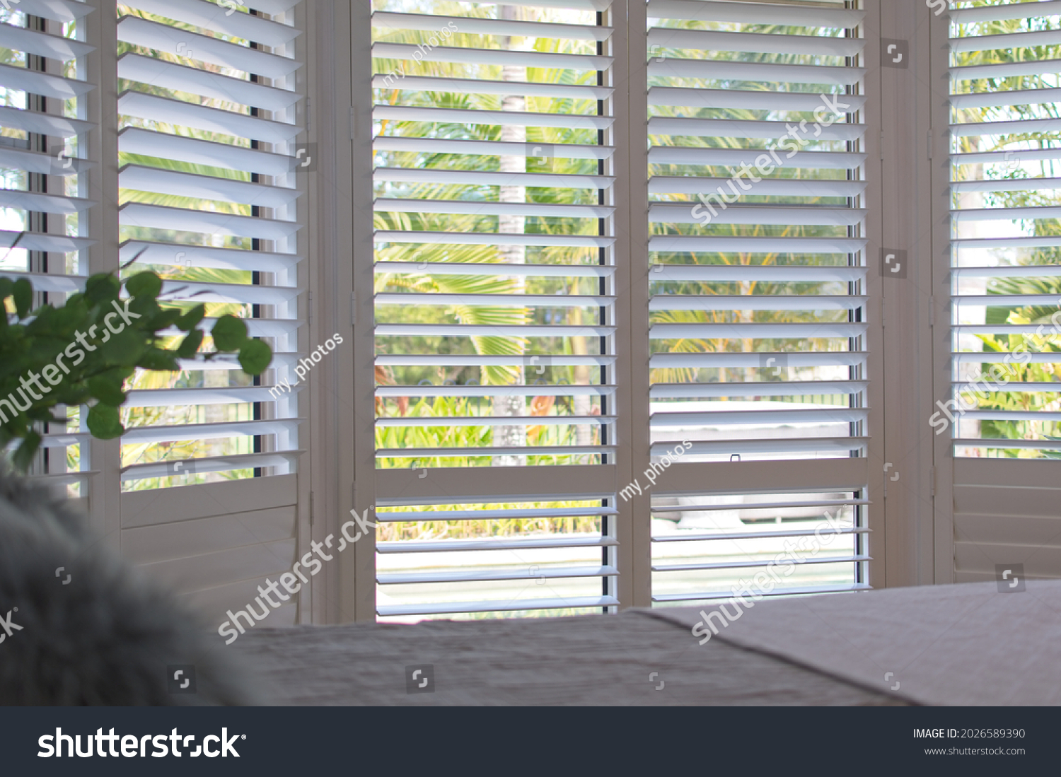 Luxury white indoor plantation shutters in bedroom - selective focus	 #2026589390