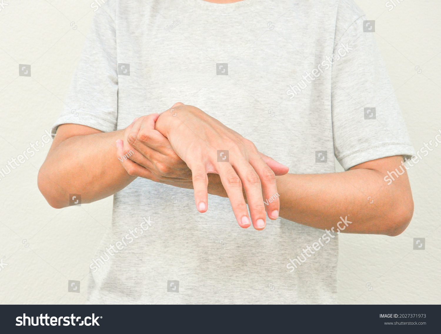 a man support his hand and arm that having symptoms of pain,numbness,weakness,paralysis,muscle disorder, concept of Guillain barre syndrome caused by autoimmune disorder #2027371973
