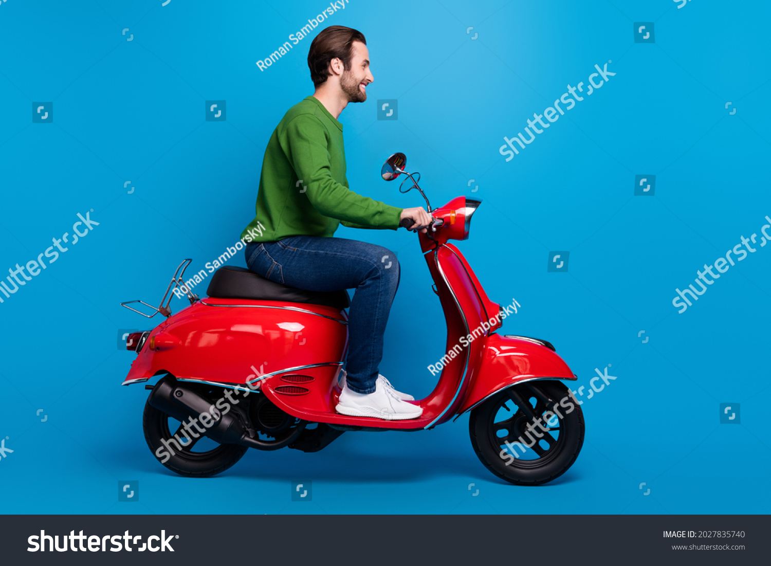 Full size profile side photo of smiling good mood man ride red moped travel freedom isolated on blue color background #2027835740