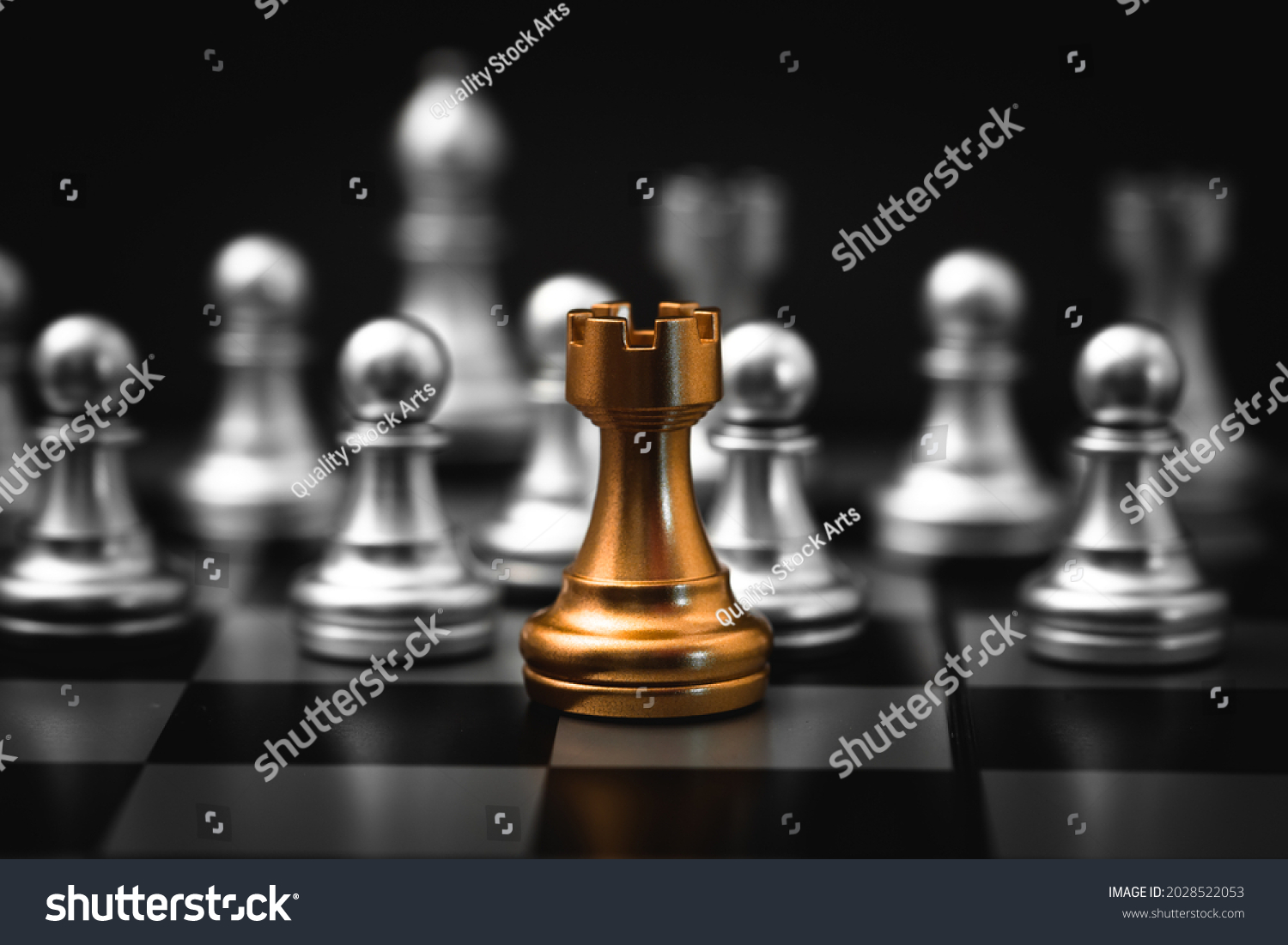 Gold Rook or Castle Tower Chess piece closeup on chess board game. Elite Company leader concept. #2028522053