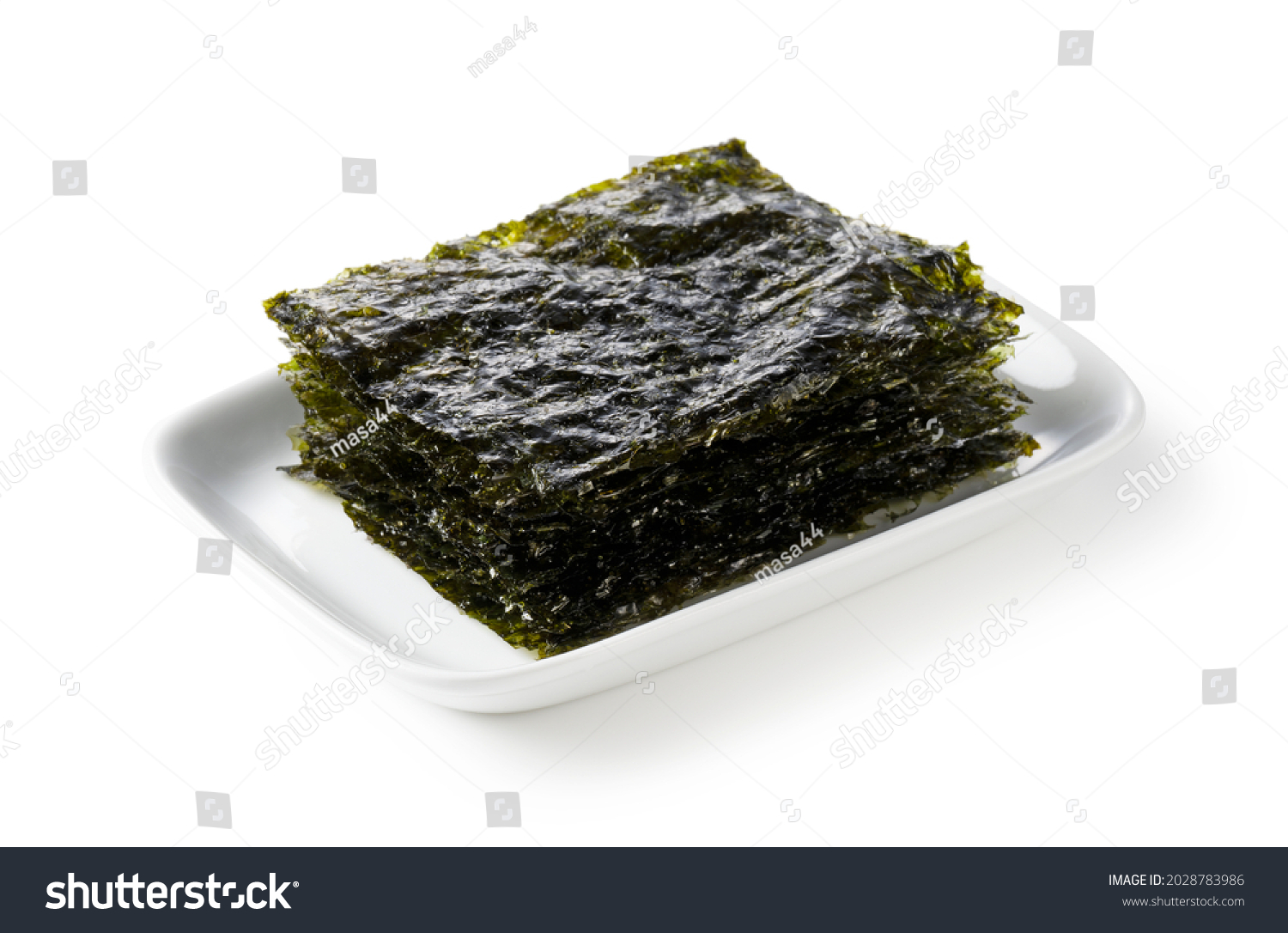 Korean seaweed on a plate set against a white background. #2028783986