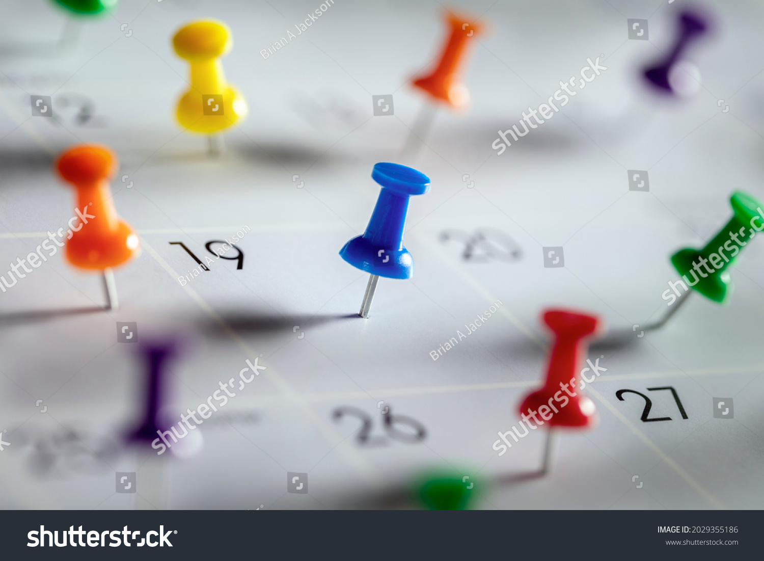 Thumbtack in calendar concept for busy, appointment and meeting reminder #2029355186