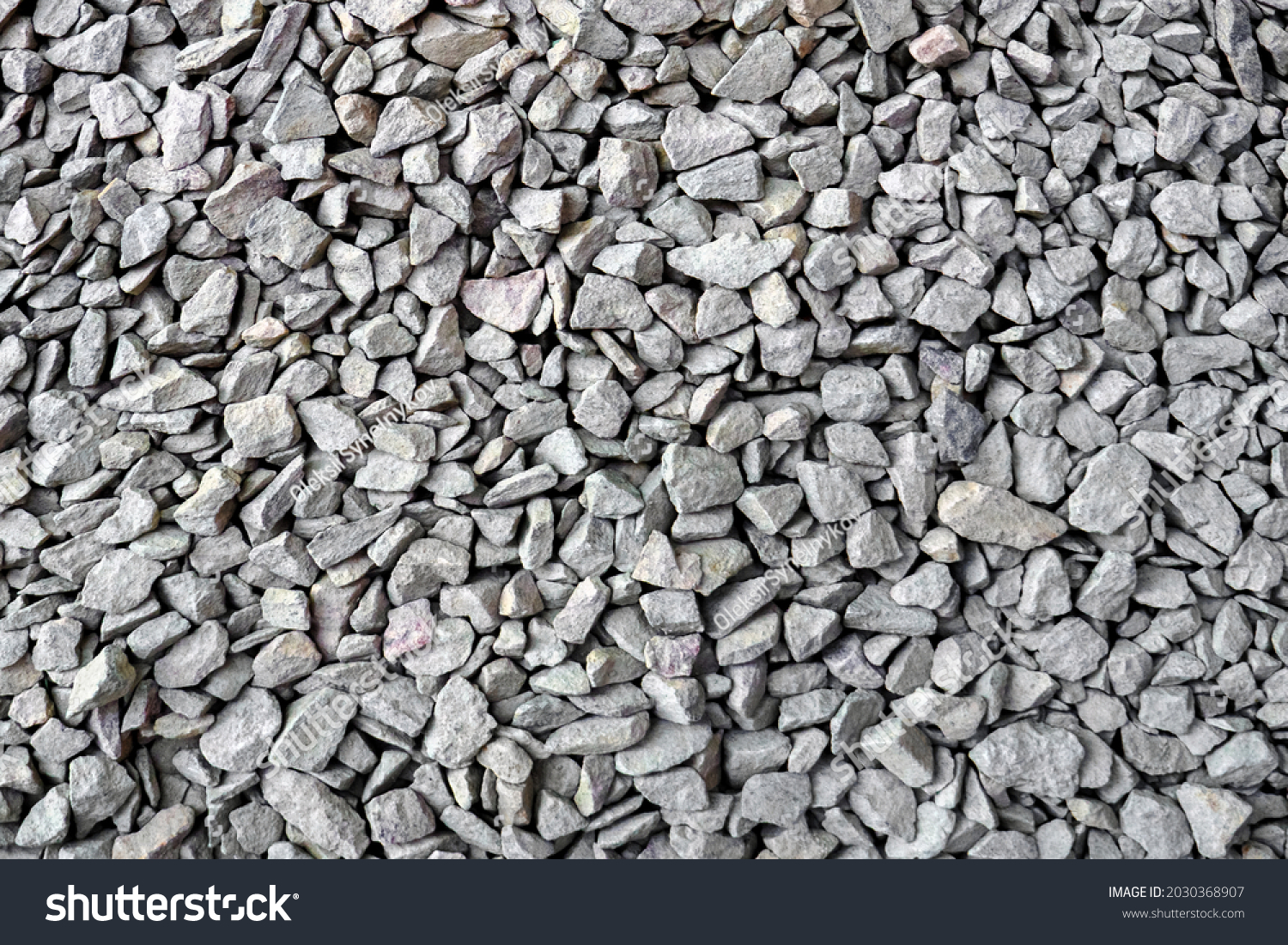 Crushed rock close up. Small rocks ground. Crushed stone road building material gravel texture. Small stone construction material rock. Garden gravel background stone landscaping. Driveway gravel road #2030368907