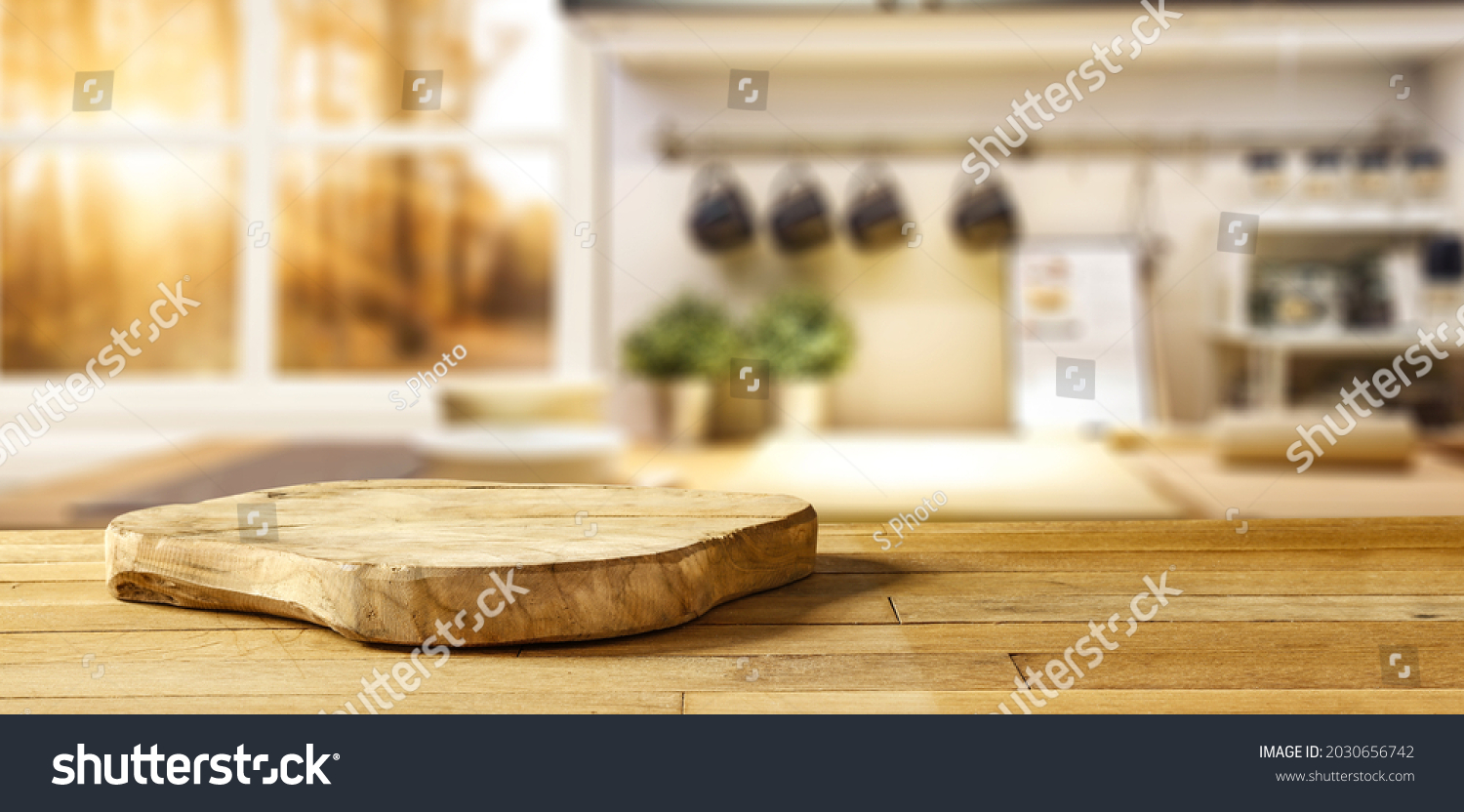 Wooden pedestal on table in kitchen interior and free space for your decoration  #2030656742