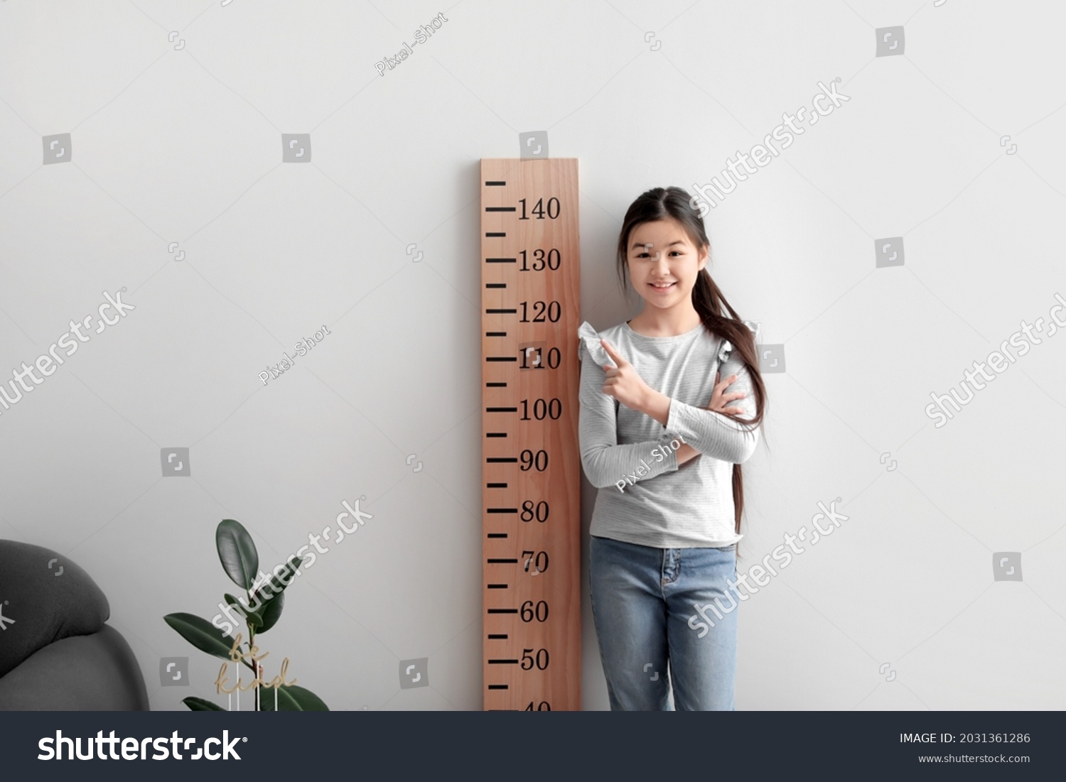 Little girl measuring height at home #2031361286