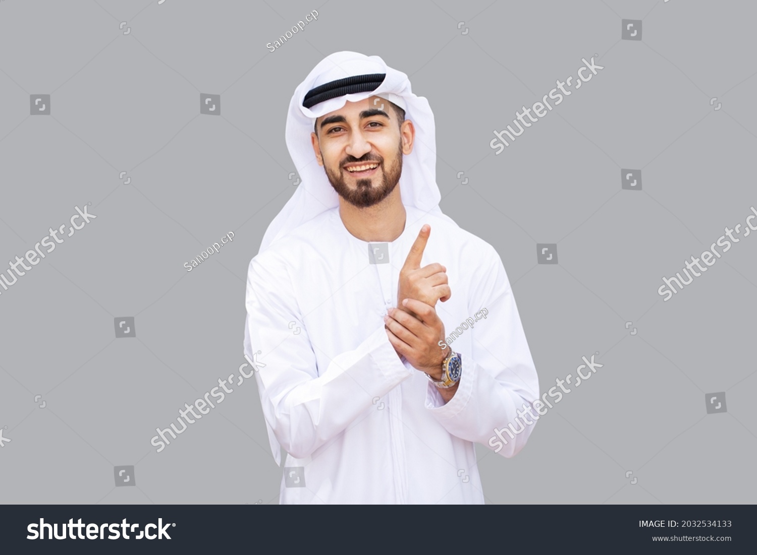Young handsome Emirati business man in UAE traditional outfit showing a variety of hand gesture. Arabic ambitious mature businessman. #2032534133
