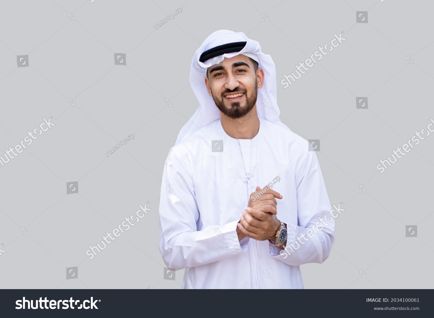 Young handsome Emirati business man in UAE traditional outfit showing a variety of hand gesture. Arabic ambitious mature businessman. #2034100061