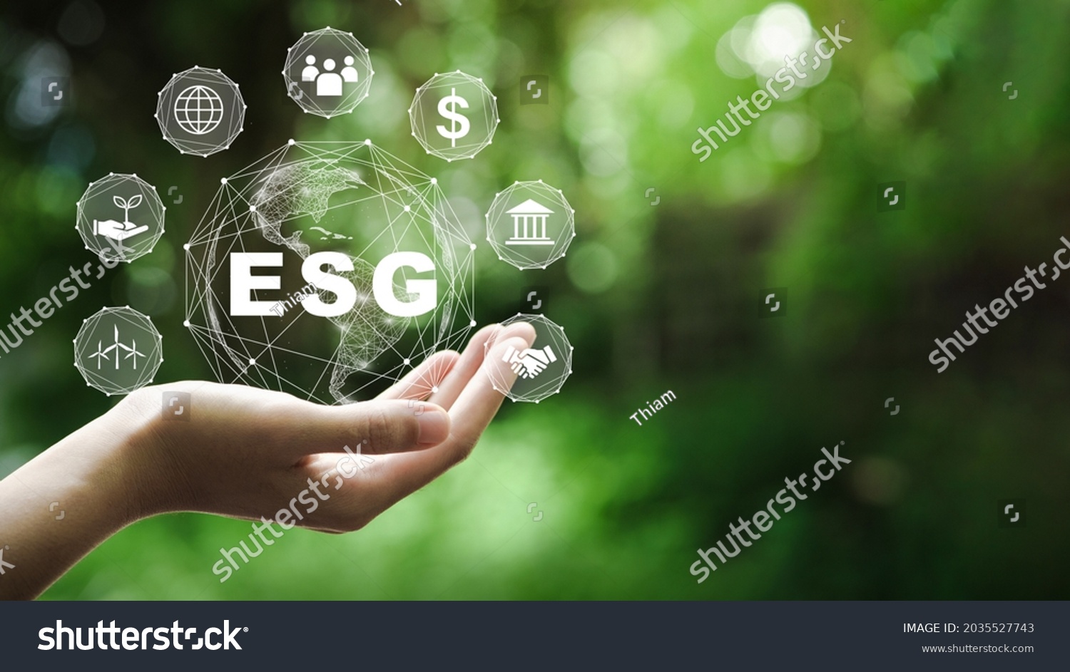 ESG icon concept in the hand for environmental, social, and governance in sustainable and ethical business on the Network connection on a green background. #2035527743