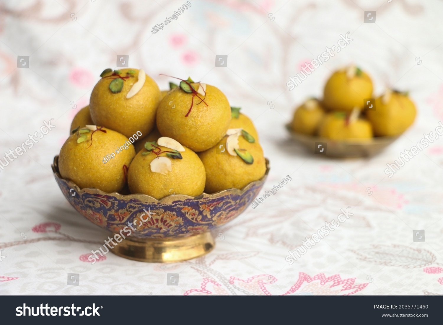 happy ganesh chaturthi, Besan laddu with dry fruits in a brass bowl on a floral background, landscape image, #2035771460