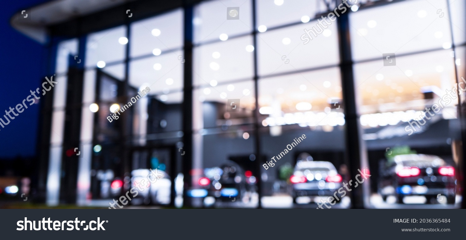 Blurred background with car dealership exterior. Abstract blurred photo of modern building motor showroom. Blur car show room office bokeh lights. Automobile retail shop #2036365484