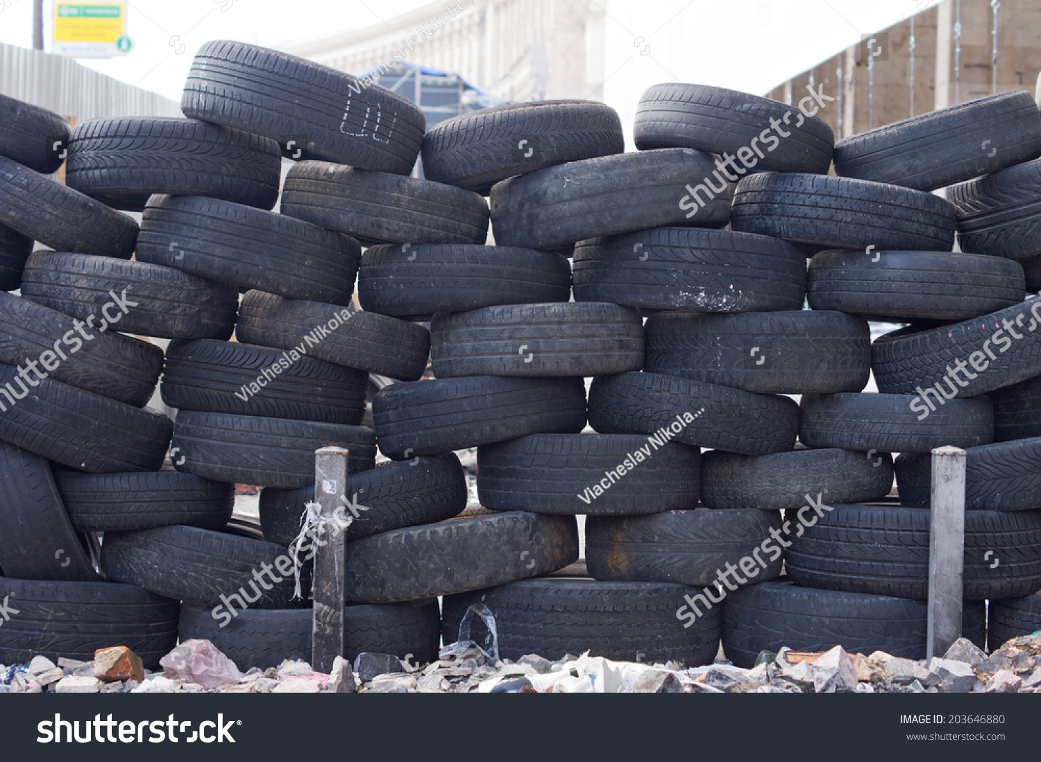 Old tires stacked to form a barricade or wall at a fairground to provide a safety feature for participants on rides and amusements #203646880
