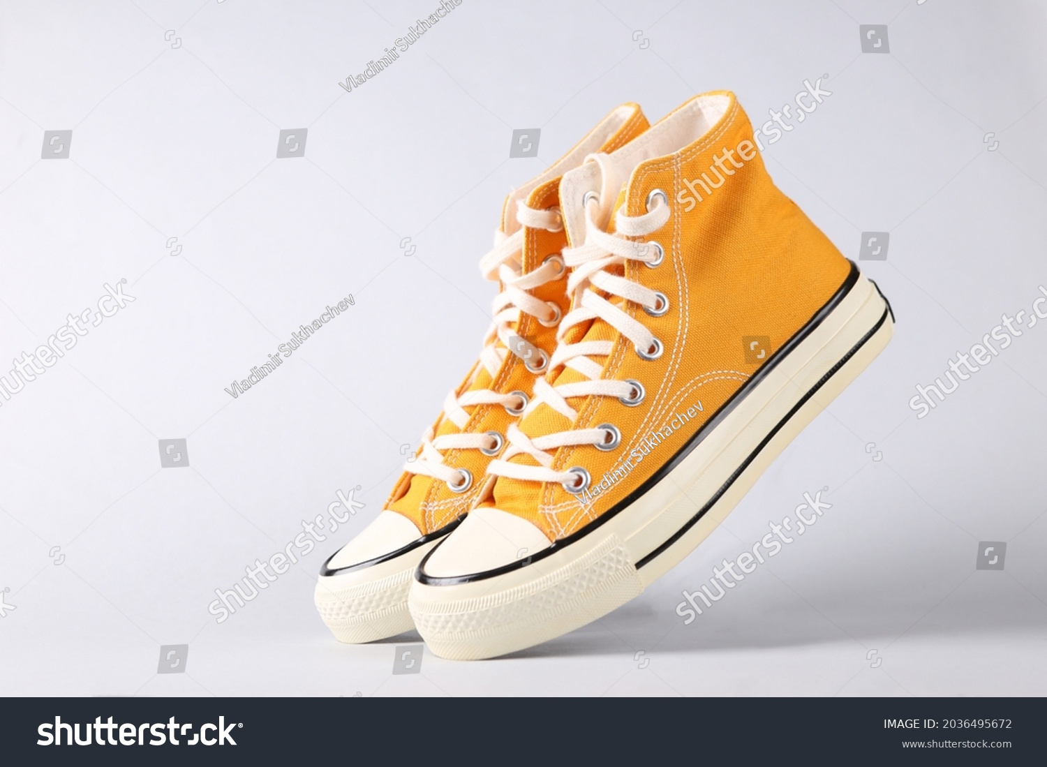Classic old school sneakers on gray background #2036495672