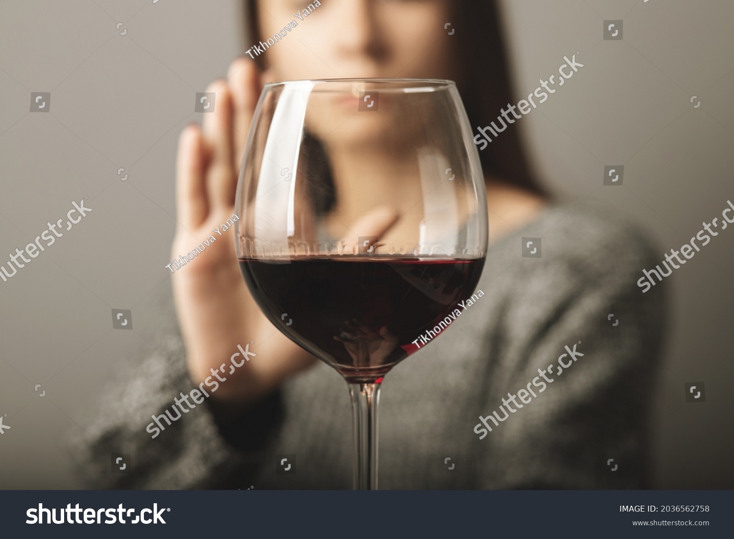 reject liquor,stop alcohol, teenager girl shows a sign of refusal of wine #2036562758