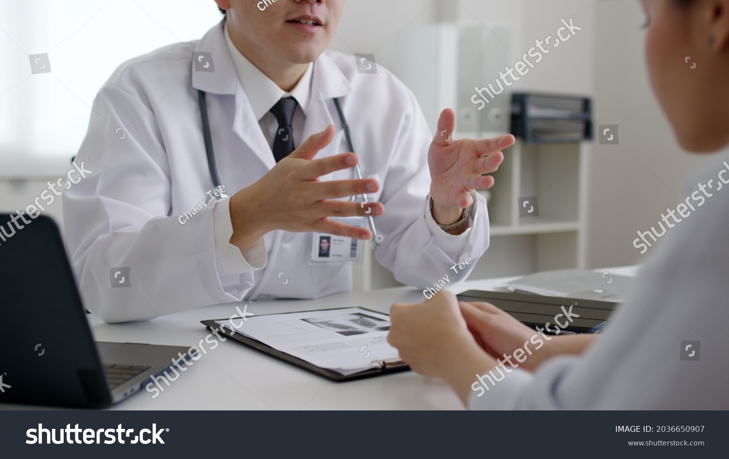 Friendly medic service people or asia male help talk discuss of medical exam record test result at clinic office desk. Young sad serious stress woman visit, follow , listen, see doctor at hospital. #2036650907