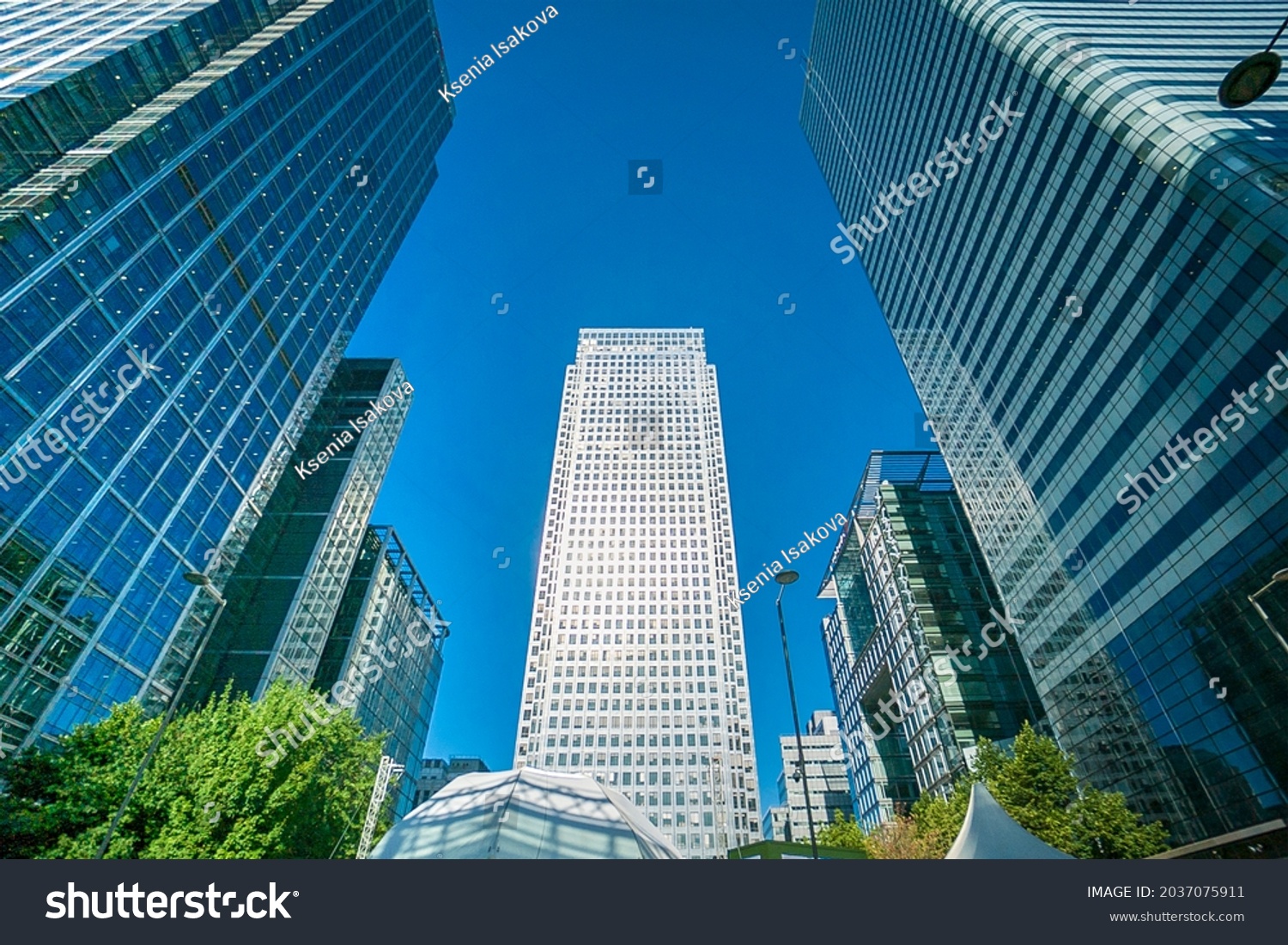 Office buildings, skyscrapers, blue sky, sunny day in the business district of London Canary Wharf, UK. Can be used for websites, brochures, posters, printing and design. #2037075911