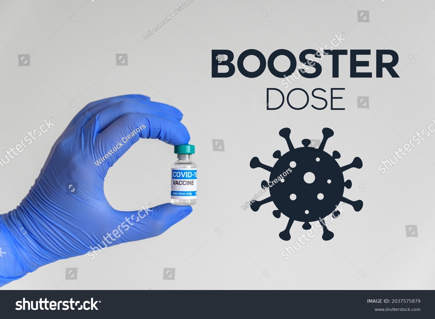 Hand in gloves holding vaccine for covid-19  Booster dose text and corona virus icon  #2037575879