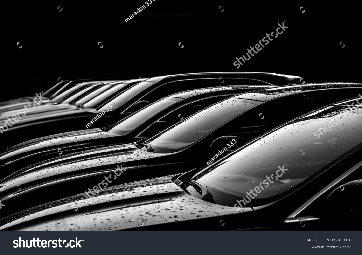 Black sedan cars standing in a row. Fleet of generic modern cars. Transportation. Luxury car fleet consisting of generic brandless design. isolated in dark background. after rain. wet surface. #2037743810